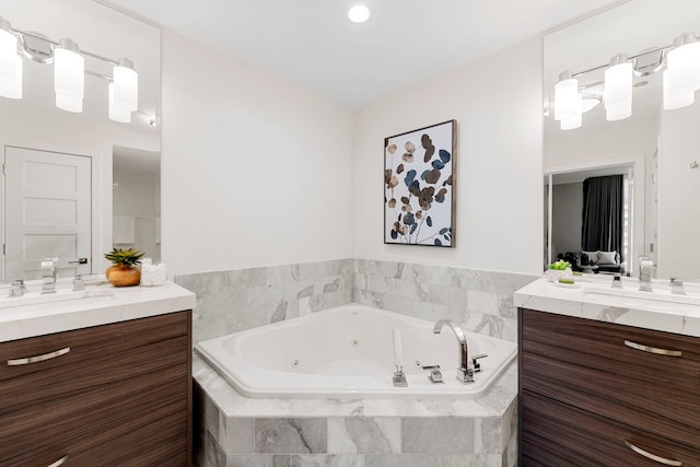 bathroom featuring vanity and a relaxing tiled tub