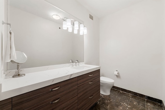 bathroom with vanity and toilet