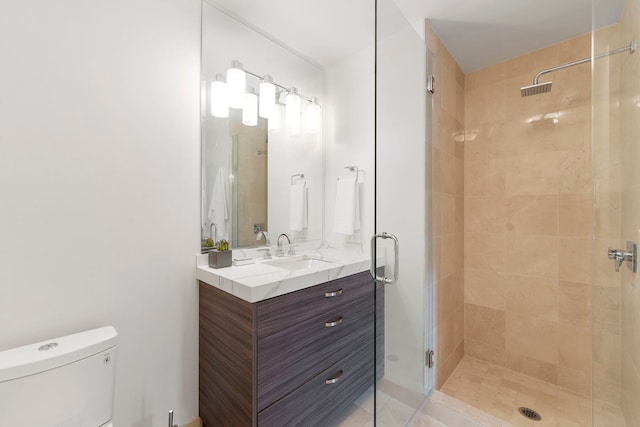 bathroom featuring vanity, toilet, and an enclosed shower