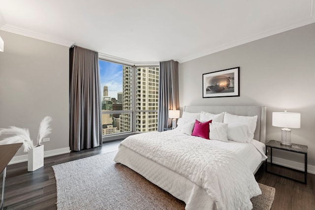 bedroom featuring expansive windows, dark hardwood / wood-style flooring, and ornamental molding