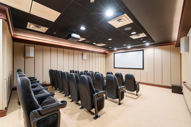 cinema room featuring light colored carpet and a drop ceiling