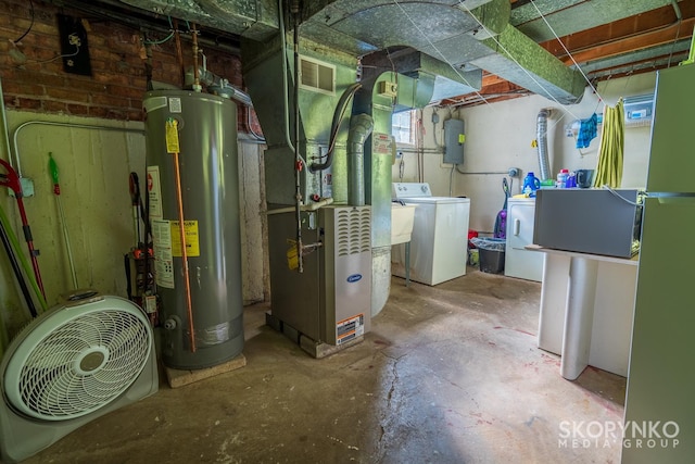 utilities featuring washing machine and dryer, heating unit, and water heater