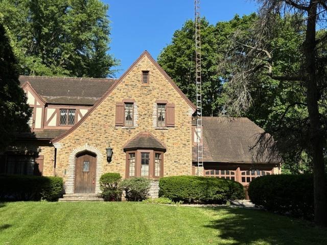 tudor house with a front lawn