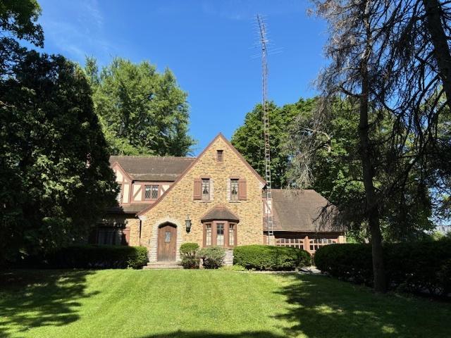 tudor-style house with a front lawn