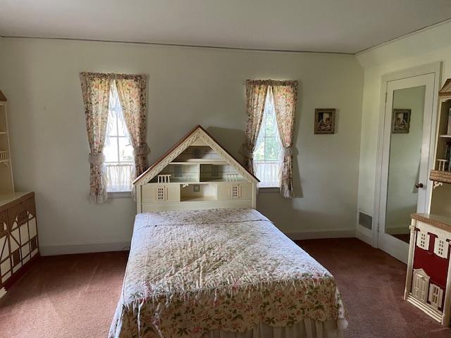 bedroom featuring dark carpet