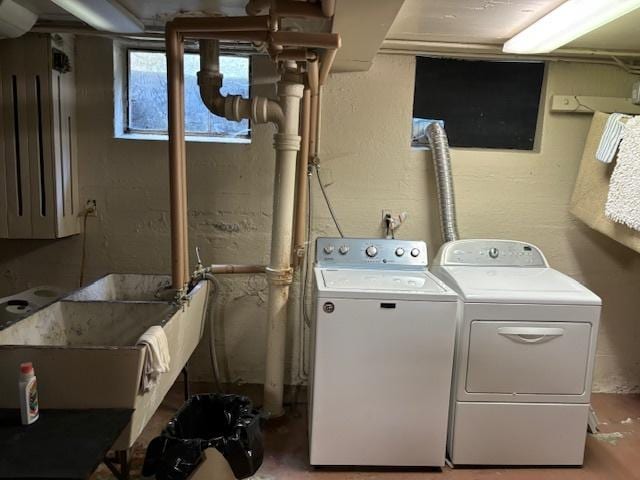 clothes washing area featuring independent washer and dryer