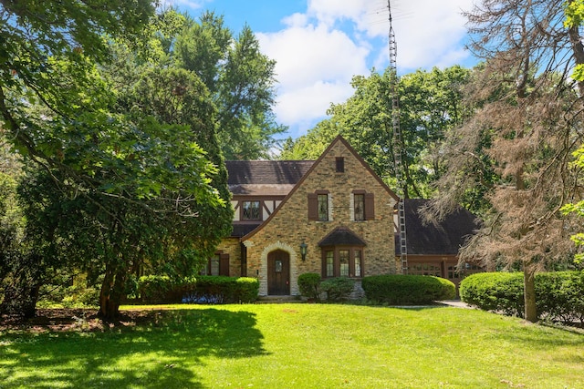 english style home with a front yard