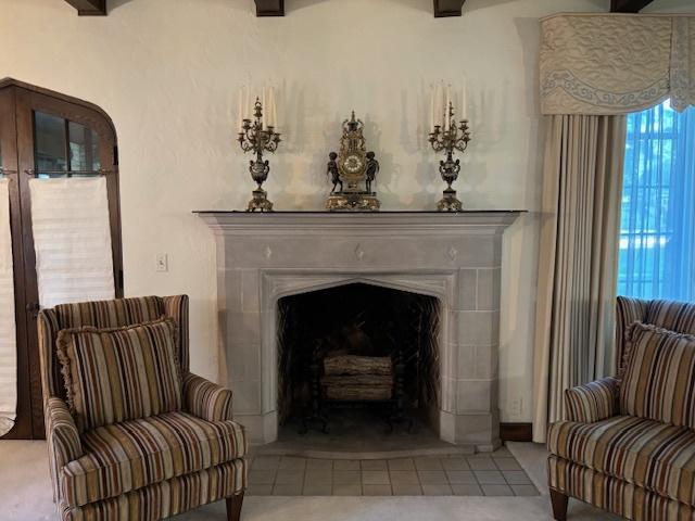 living area featuring beam ceiling