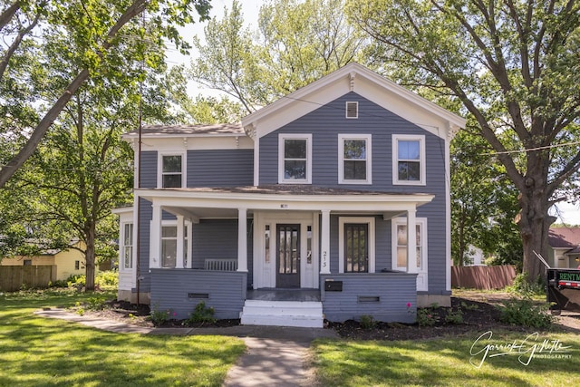 view of front of home with covered porch and a front yard