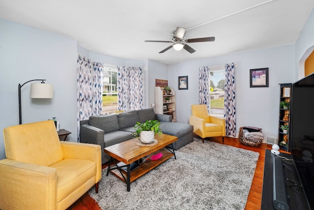 living room featuring wood-type flooring and ceiling fan