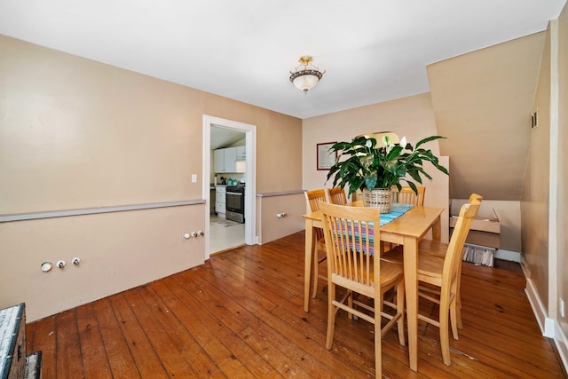 dining space featuring wood-type flooring