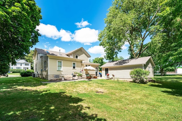 rear view of property with a patio area, central air condition unit, and a yard