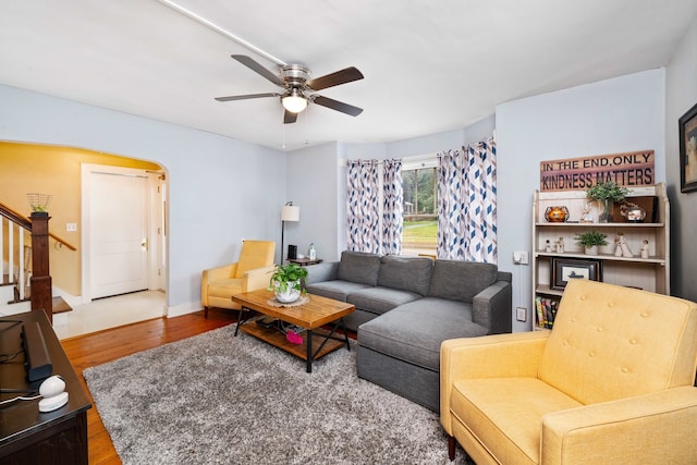 living room featuring hardwood / wood-style flooring and ceiling fan