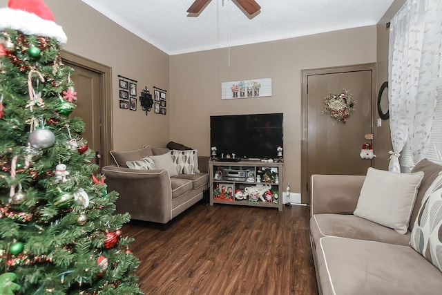 living room featuring a textured ceiling, dark hardwood / wood-style floors, and ceiling fan