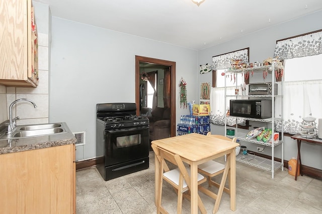 kitchen featuring black appliances, light brown cabinets, and sink