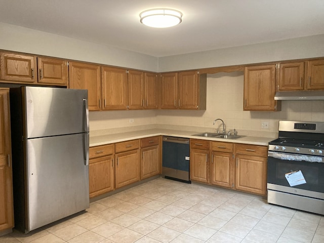 kitchen featuring appliances with stainless steel finishes, tasteful backsplash, sink, and light tile patterned floors