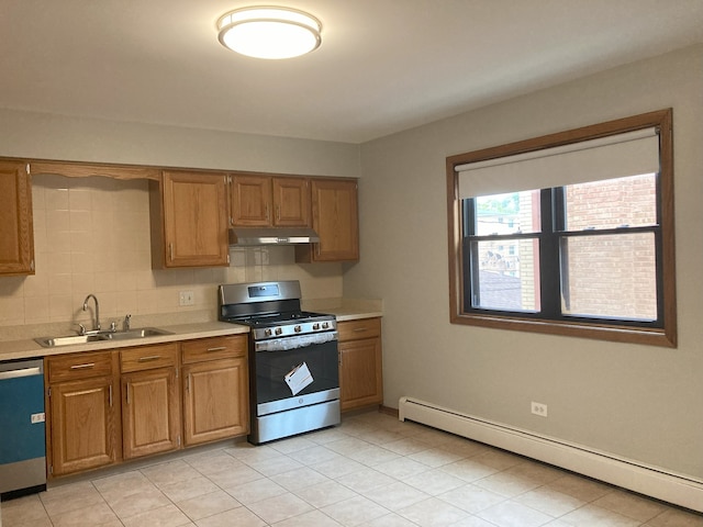 kitchen with decorative backsplash, a baseboard radiator, light tile patterned floors, appliances with stainless steel finishes, and sink