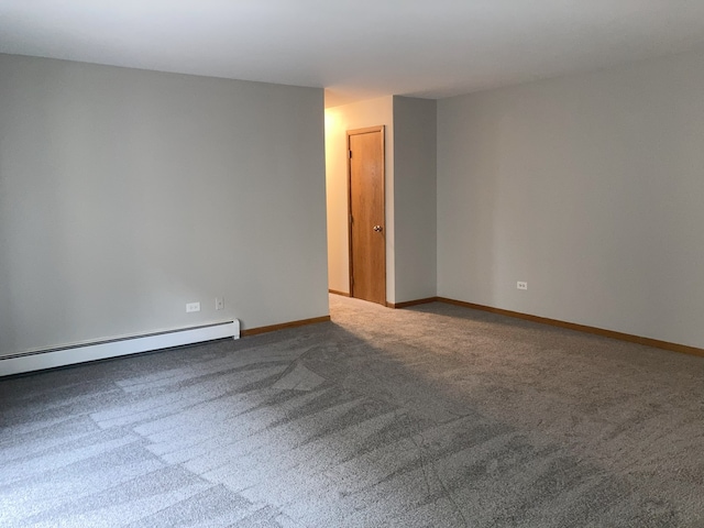 carpeted spare room with baseboard heating