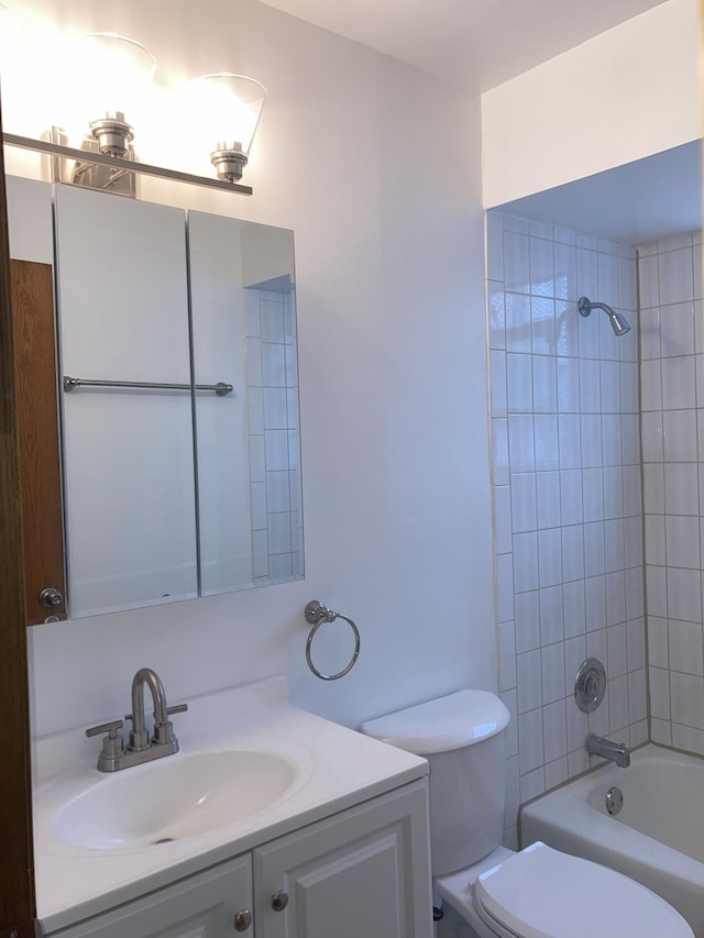 full bathroom featuring vanity, toilet, and tiled shower / bath combo