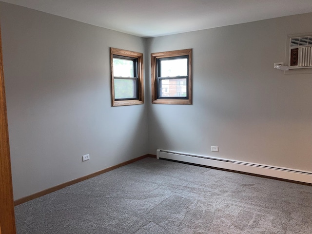 carpeted spare room featuring an AC wall unit and a baseboard heating unit