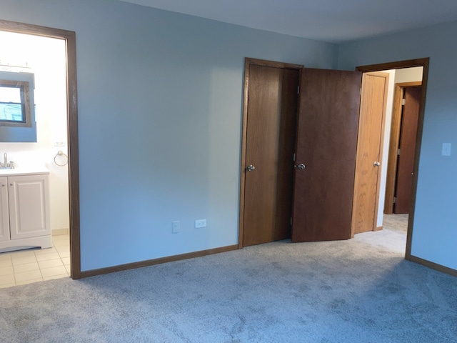 unfurnished bedroom featuring light carpet