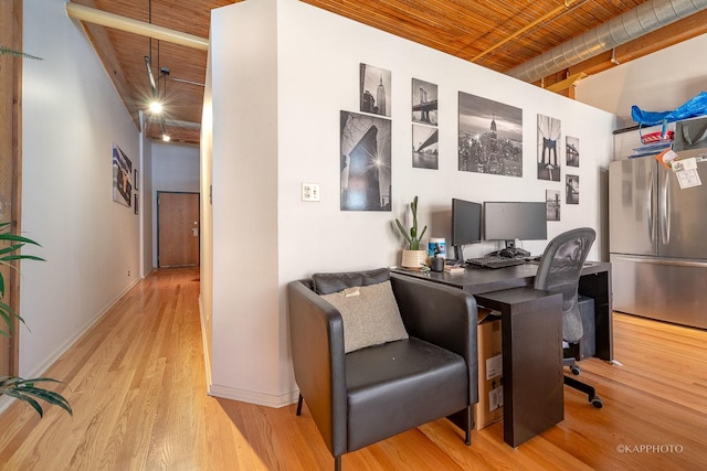 office area with light wood-type flooring and wood ceiling