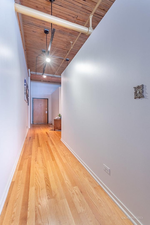 hallway featuring wooden ceiling and light hardwood / wood-style flooring