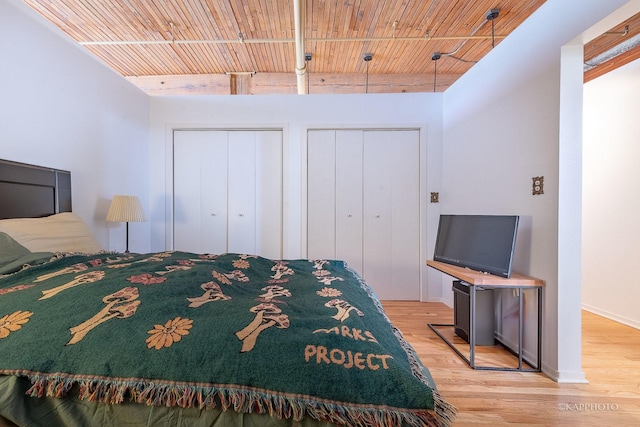 bedroom with wood ceiling and light hardwood / wood-style floors