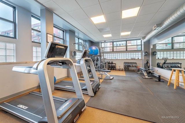 gym with a paneled ceiling