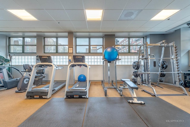 gym with a paneled ceiling