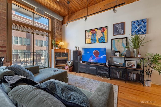 living room with wood ceiling, brick wall, and hardwood / wood-style flooring