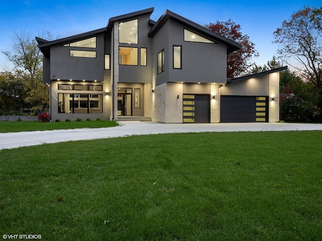 modern home with a garage and a lawn