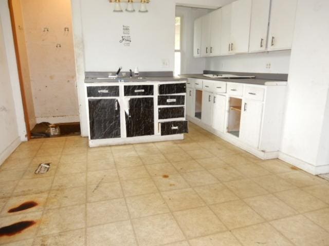 kitchen with white cabinetry and sink