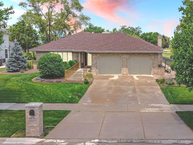 view of front of property with a lawn and a garage