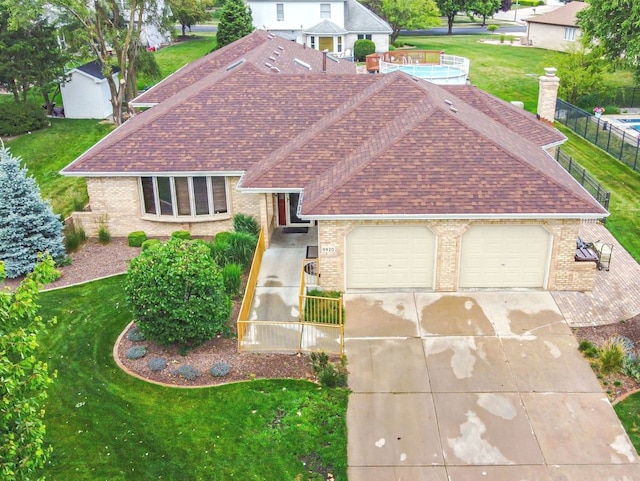 view of front of property featuring a garage and a front lawn