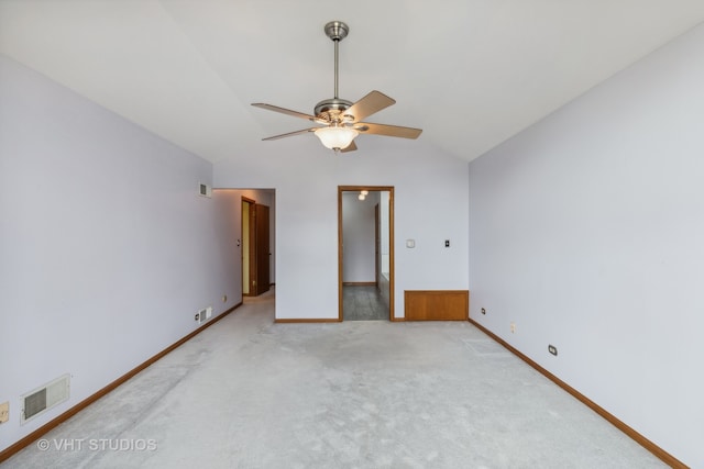 unfurnished bedroom featuring lofted ceiling, light colored carpet, and ceiling fan