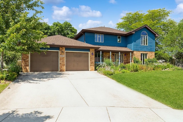 traditional-style house with brick siding, a shingled roof, an attached garage, driveway, and a front lawn