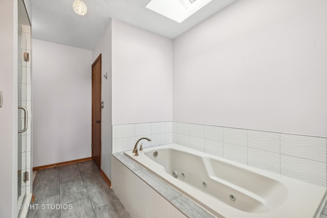 bathroom with plus walk in shower and a skylight