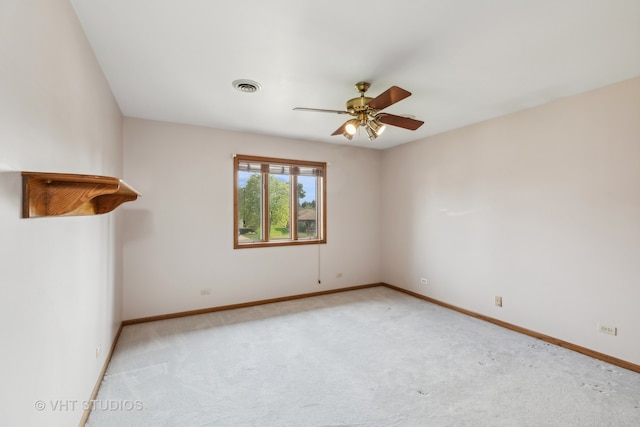 carpeted empty room featuring ceiling fan