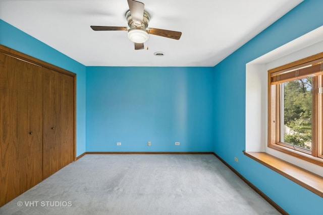 unfurnished bedroom with carpet floors, baseboards, visible vents, and a closet