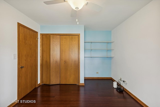 unfurnished bedroom with a closet, wood finished floors, a ceiling fan, and baseboards