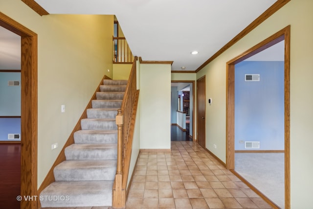 staircase featuring tile patterned flooring and ornamental molding