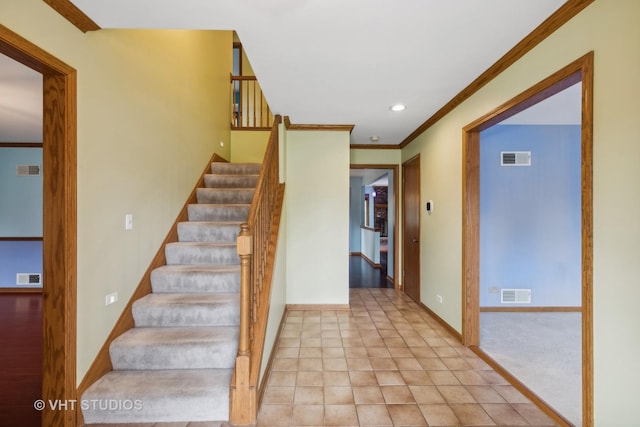 stairs featuring ornamental molding, visible vents, and baseboards