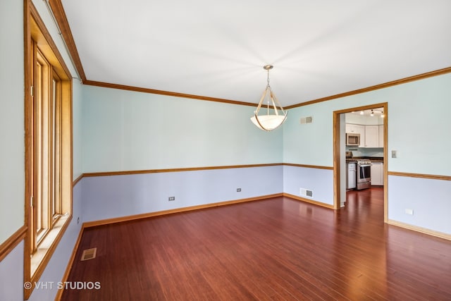 unfurnished room featuring ornamental molding and dark hardwood / wood-style flooring