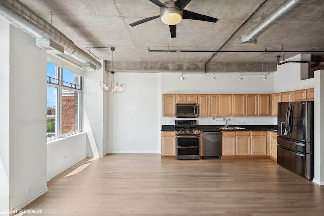 kitchen with appliances with stainless steel finishes, light hardwood / wood-style floors, sink, and light brown cabinets