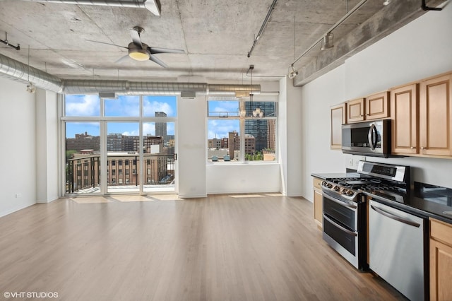 kitchen featuring light hardwood / wood-style flooring, light brown cabinets, appliances with stainless steel finishes, pendant lighting, and ceiling fan with notable chandelier