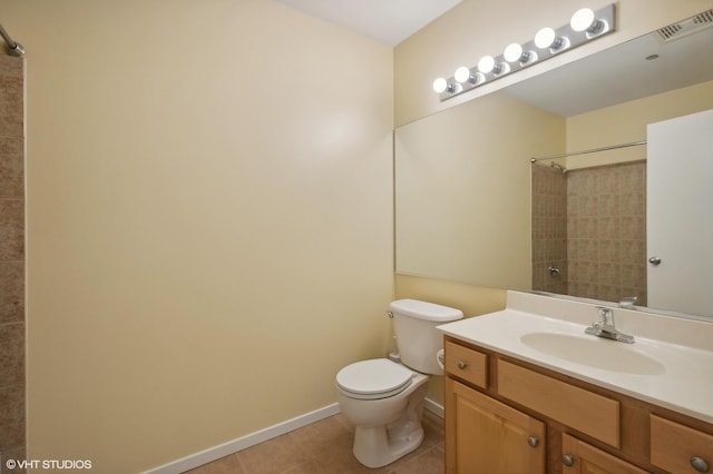 bathroom featuring tile patterned flooring, a shower, vanity, and toilet