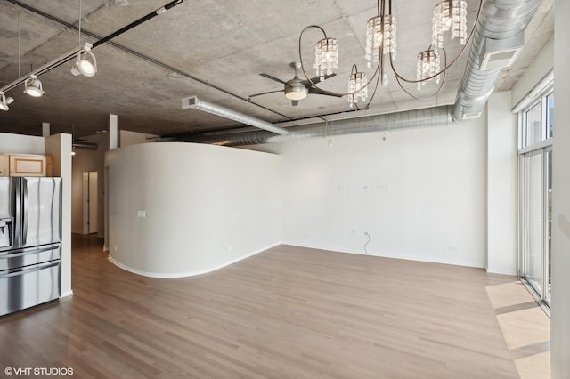 interior space with ceiling fan, stainless steel fridge with ice dispenser, and hardwood / wood-style floors