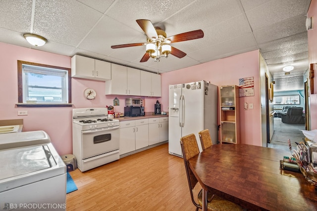 kitchen featuring a drop ceiling, ceiling fan, white cabinetry, light wood-type flooring, and white appliances