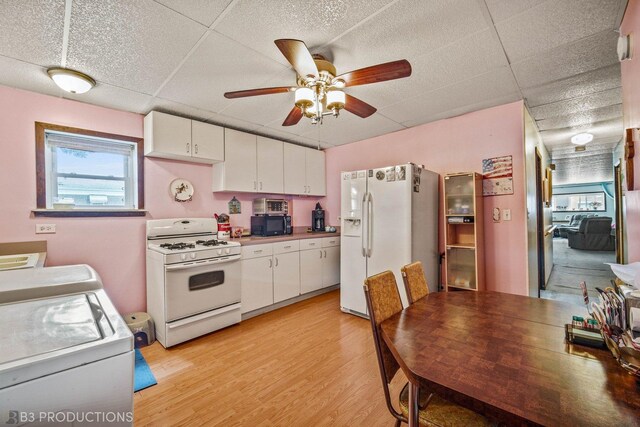 3600 S Union Ave, Chicago, IL 60609 - kitchen featuring white appliances, light wood-style floors, white cabinetry, a ceiling fan, and a drop ceiling